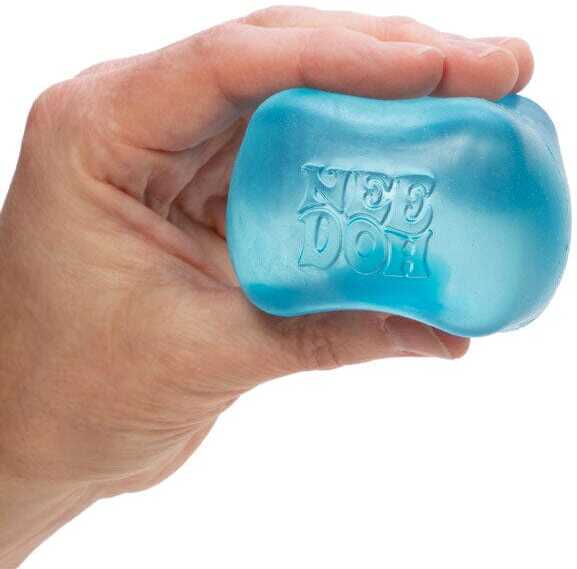 An adult hand squeezing a translucent blue NeeDoh squishy stress ball, fingers pressing into the soft jelly surface